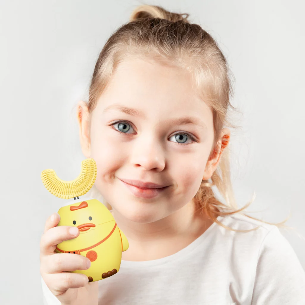 Photo of a child using a U-shaped electric toothbrush
