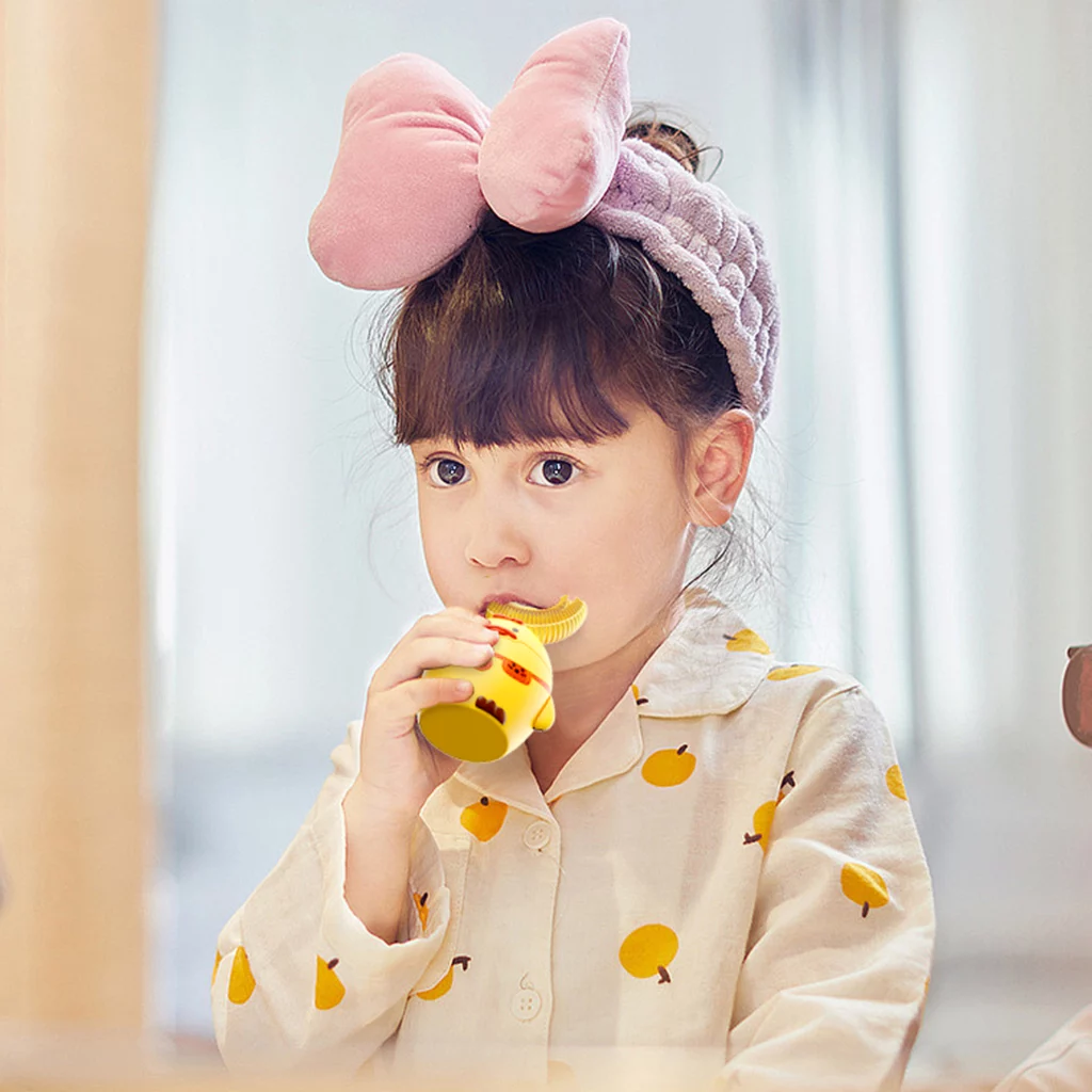 Photo of a child using a U-shaped electric toothbrush