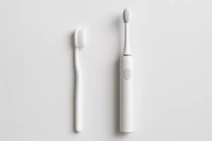 Manual vs Electric Toothbrush side-by-side on white background