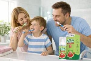Parent supervising child brushing teeth as part of a kids oral care routine