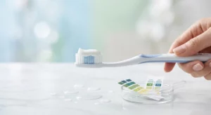A toothbrush with toothpaste representing the ideal pH of toothpaste for enamel protection