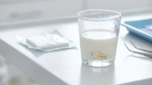 Emergency guide on how to handle a knocked-out tooth stored in a glass of milk